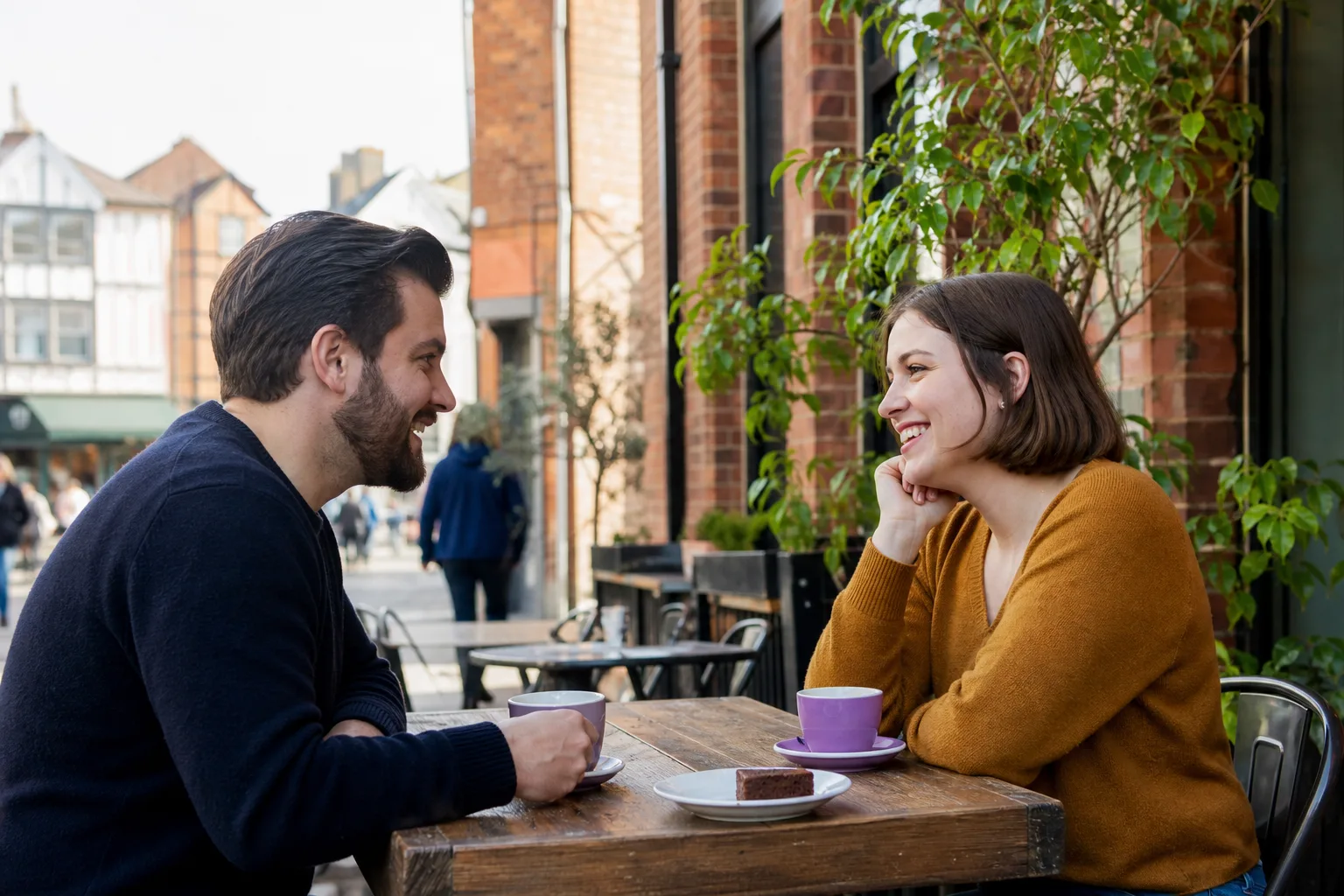Two people talking over coffee beside the River Thames in Reading